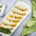 a top-down shot of spanakopita rolls on a plate.