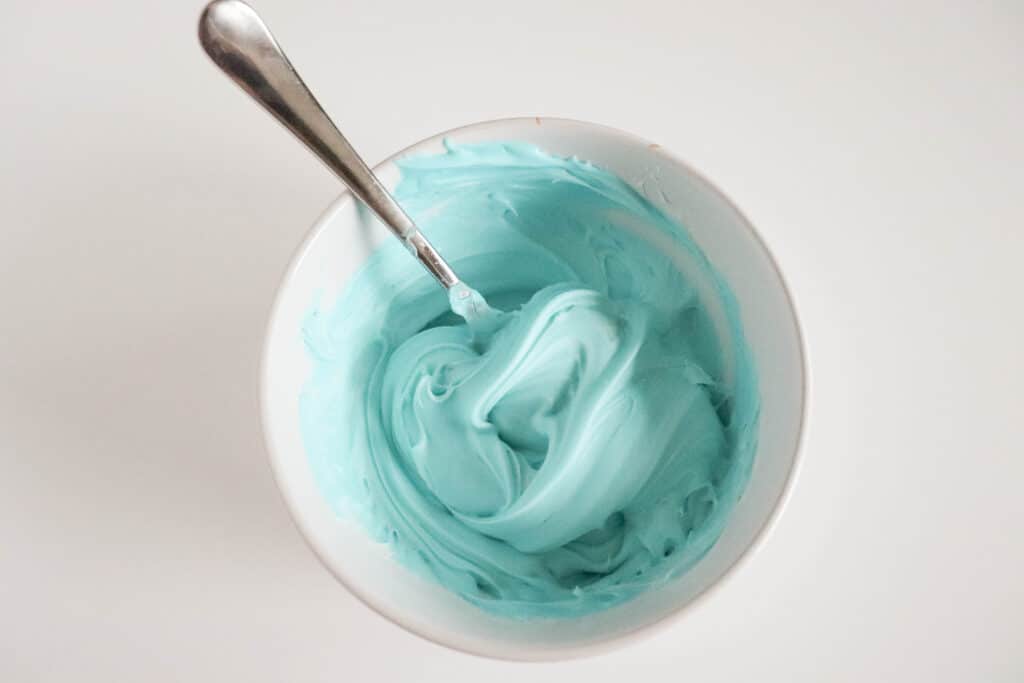 tinted frosting to decorate mini egg cookies