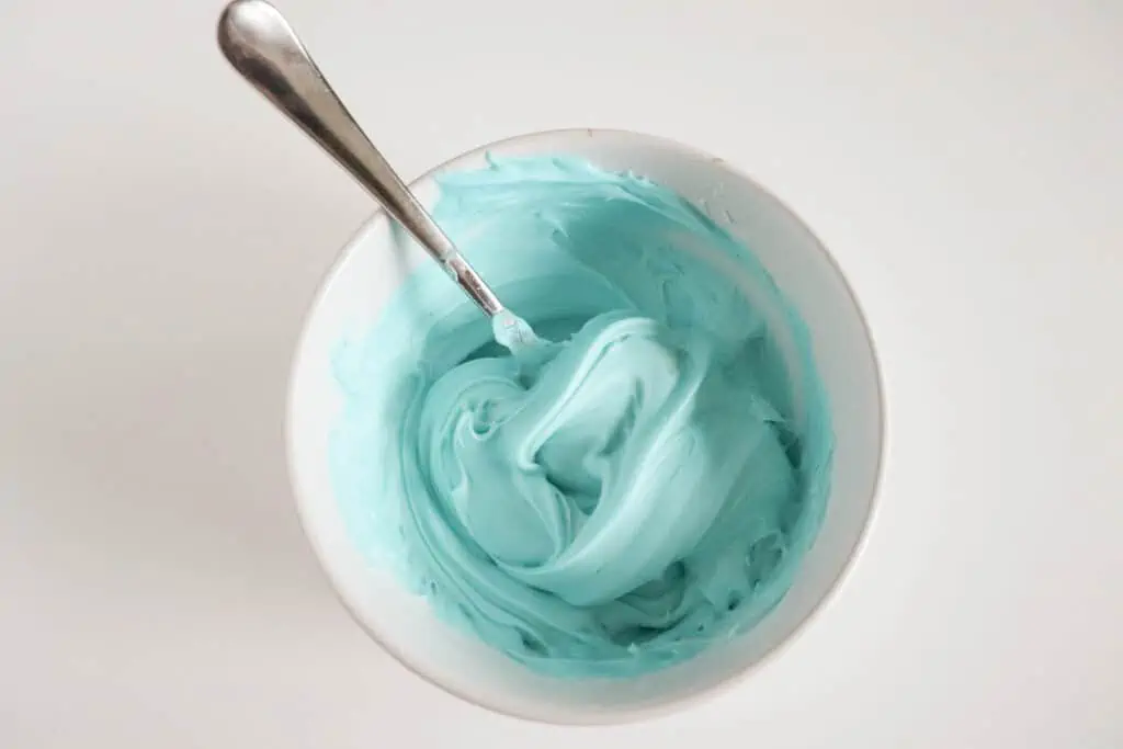 tinted frosting to decorate mini egg cookies