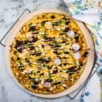 birria pizza on a pizza stone