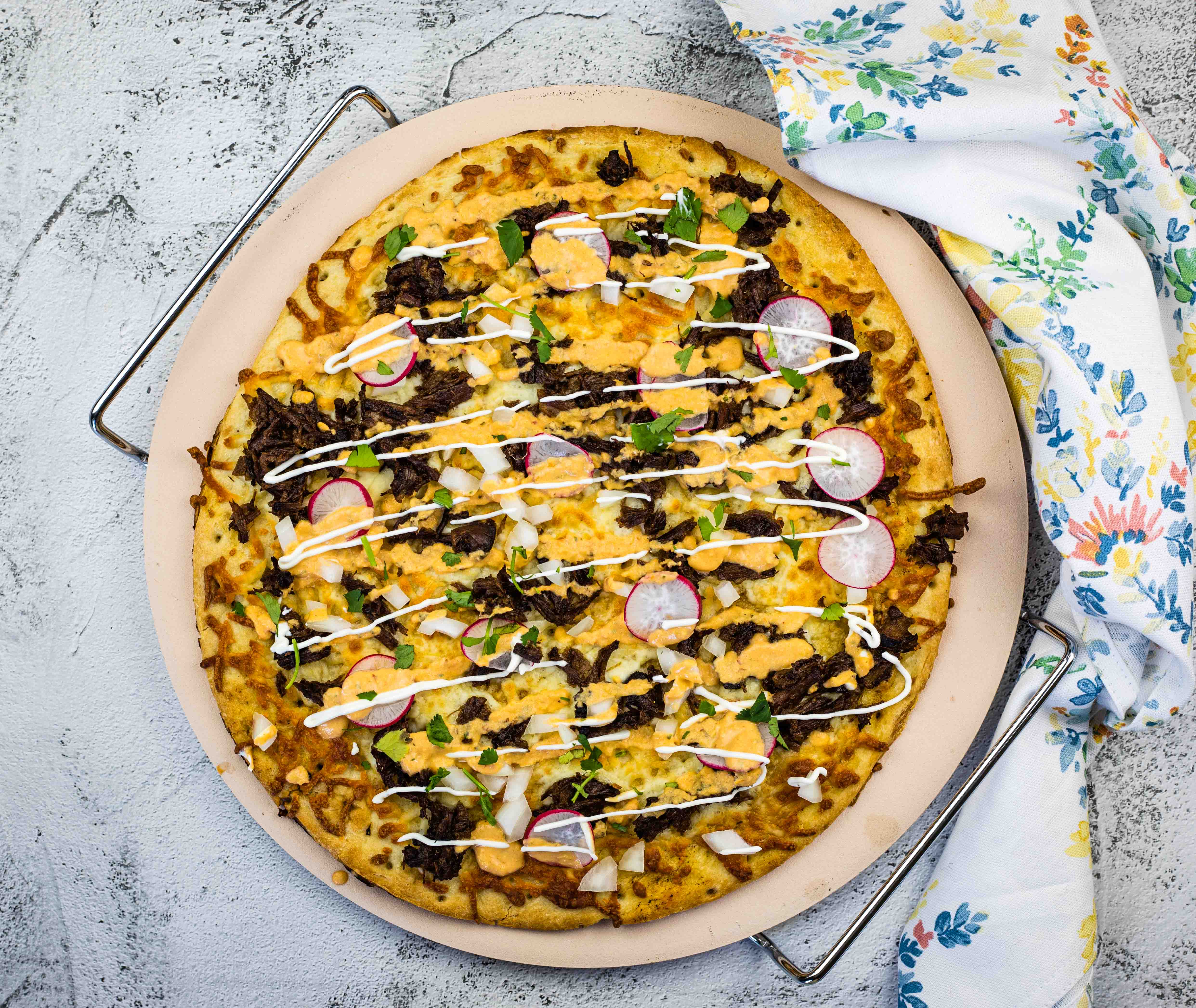 Birria Pizza on a pizza stone.