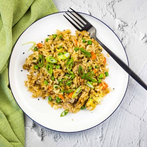 Chicken Fried Rice made on the blackstone griddle on a white plate.