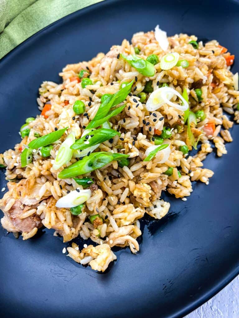 chicken fried rice on the blackstone griddle served on a black plate