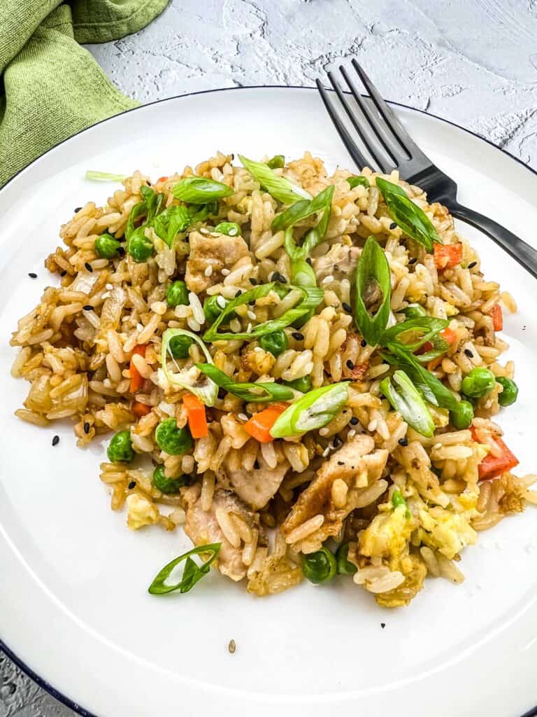 chicken fried rice on the blackstone griddle served on a white plate
