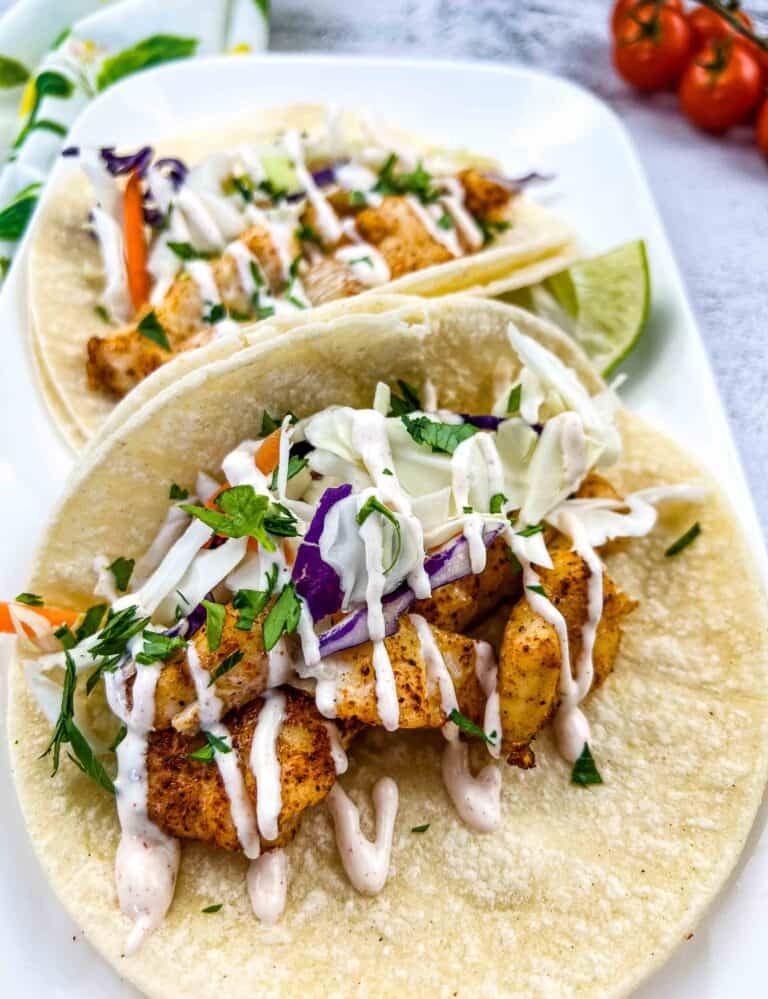 baja fish tacos with cod on a white plate