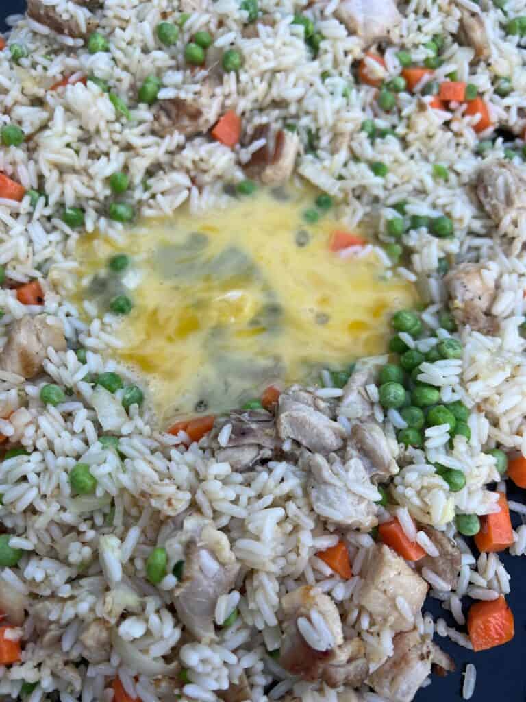 cooking the egg in a hole in the center of the rice.