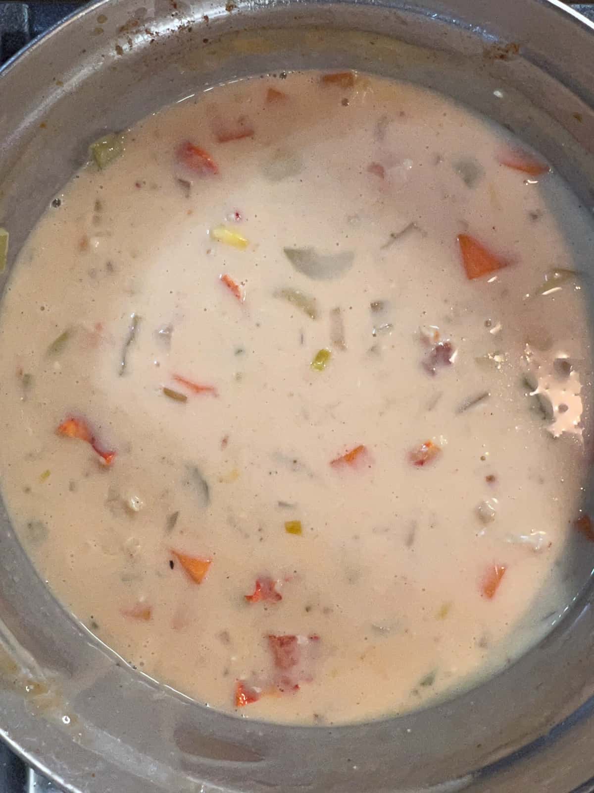corn, potatoes, cream and lobster added to soup