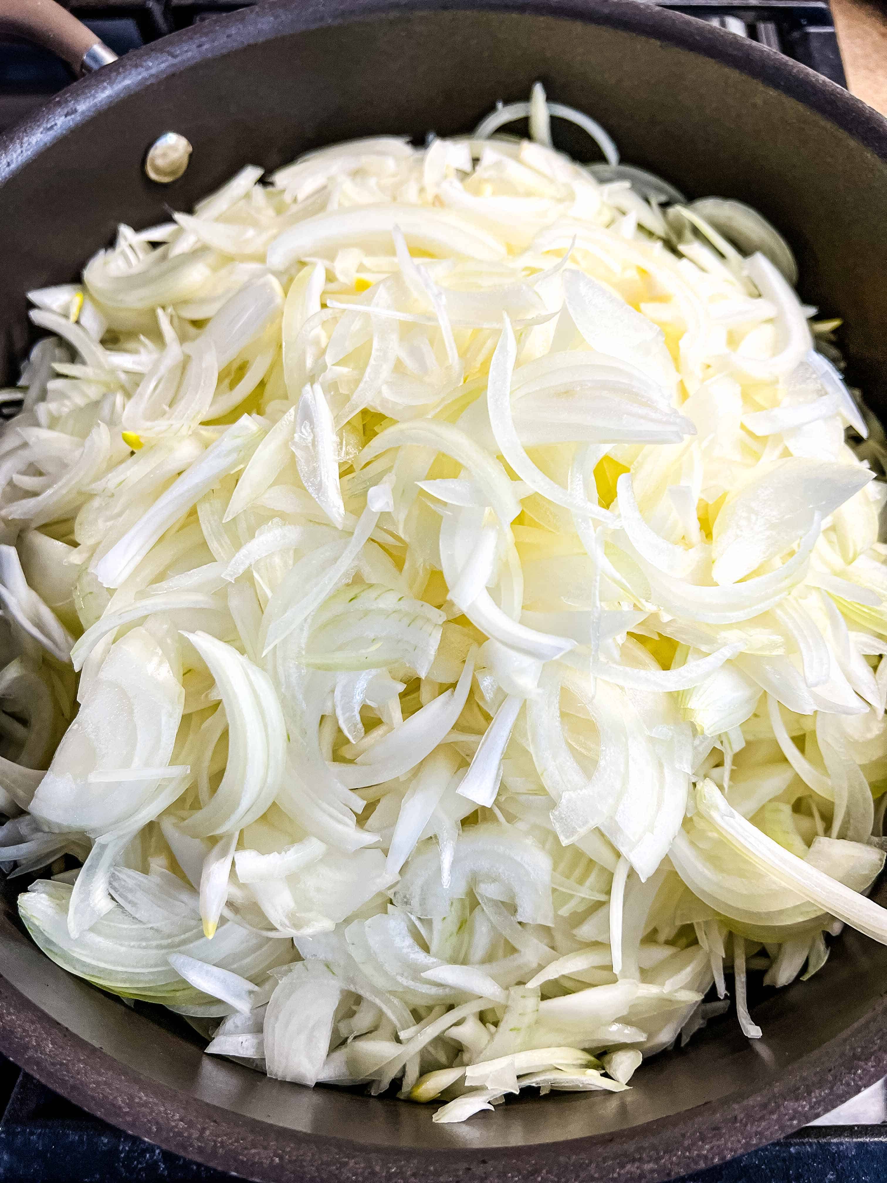 a mountain of onions in a skillet to make caramelized onions