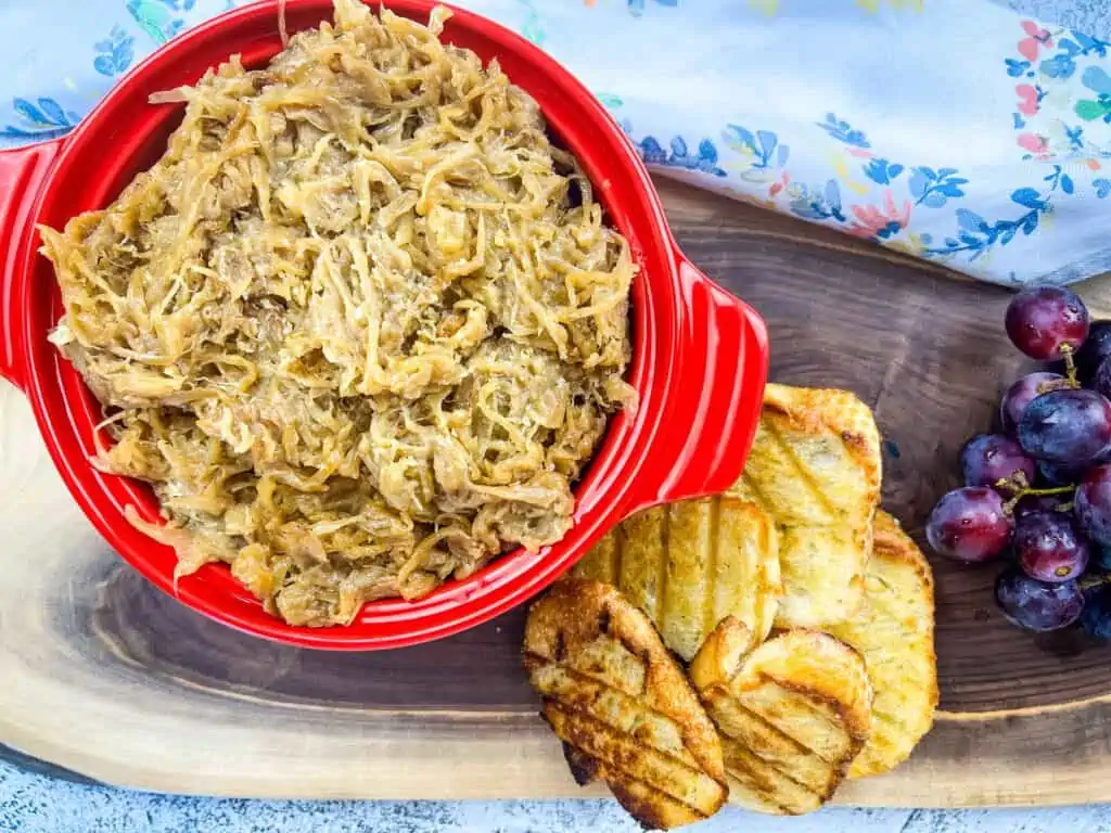 creamy caramelized onions on a platter with bread