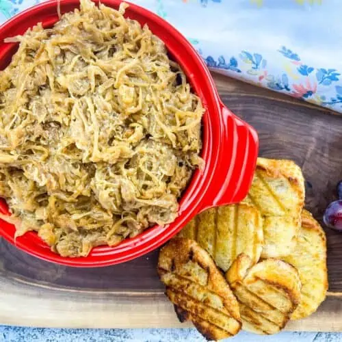 creamy caramelized onions on a platter with bread