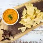 chile de arbol salsa on a platter with chips