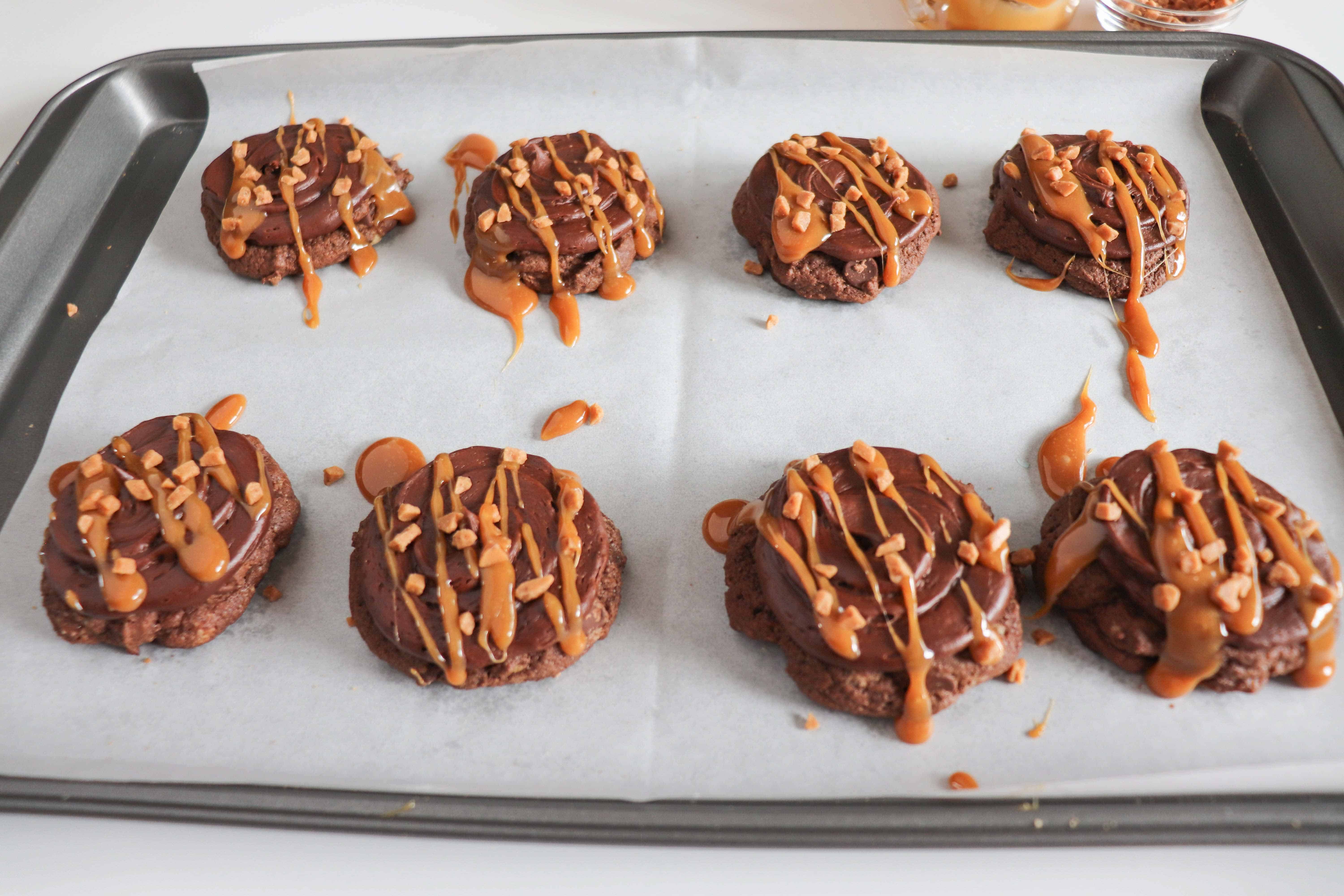 chocolate caramel cookies on a baking sheet ready to eat