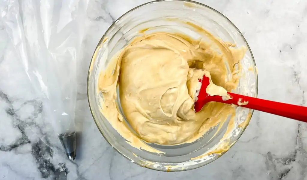 dulce de leche mixed with whipping cream in a bowl