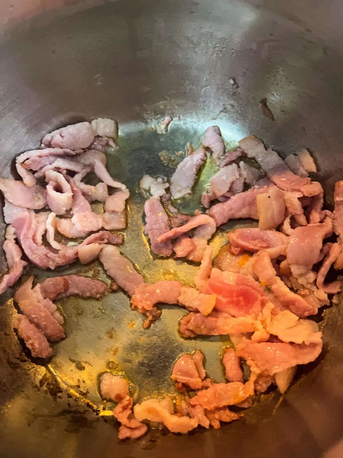 frying the bacon in the soup pot