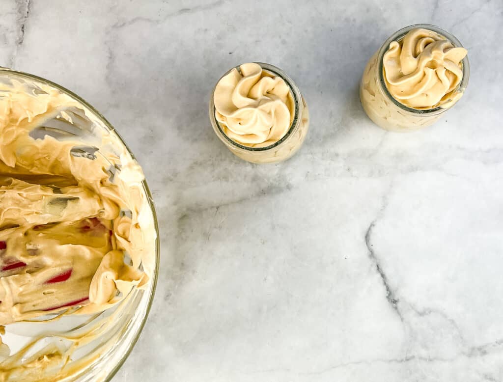2 dessert cups filled with dulce de leche mousse