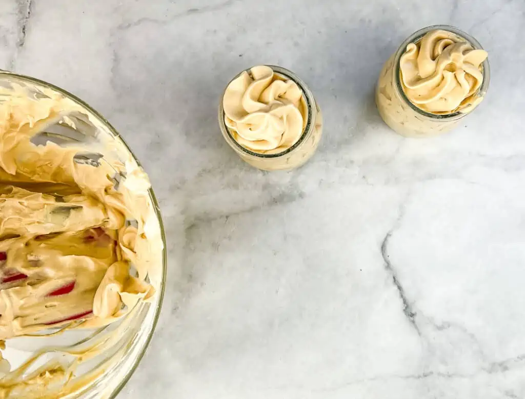 2 dessert cups filled with dulce de leche mousse