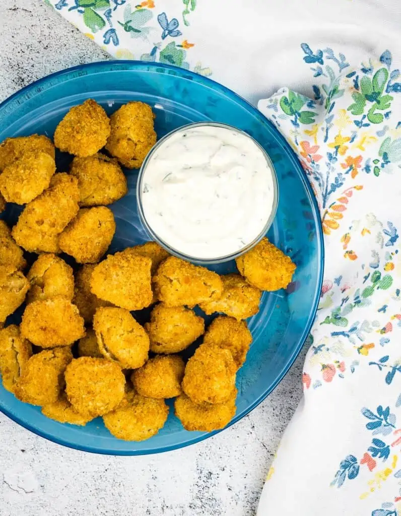 popcorn chicken on a plate with dipping sauce