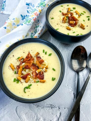 potato bacon cheddar soup in two bowls with spoons