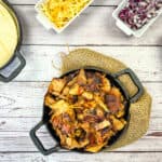 instant precision dutch oven carnitas on a cast iron skillet with taco fixings