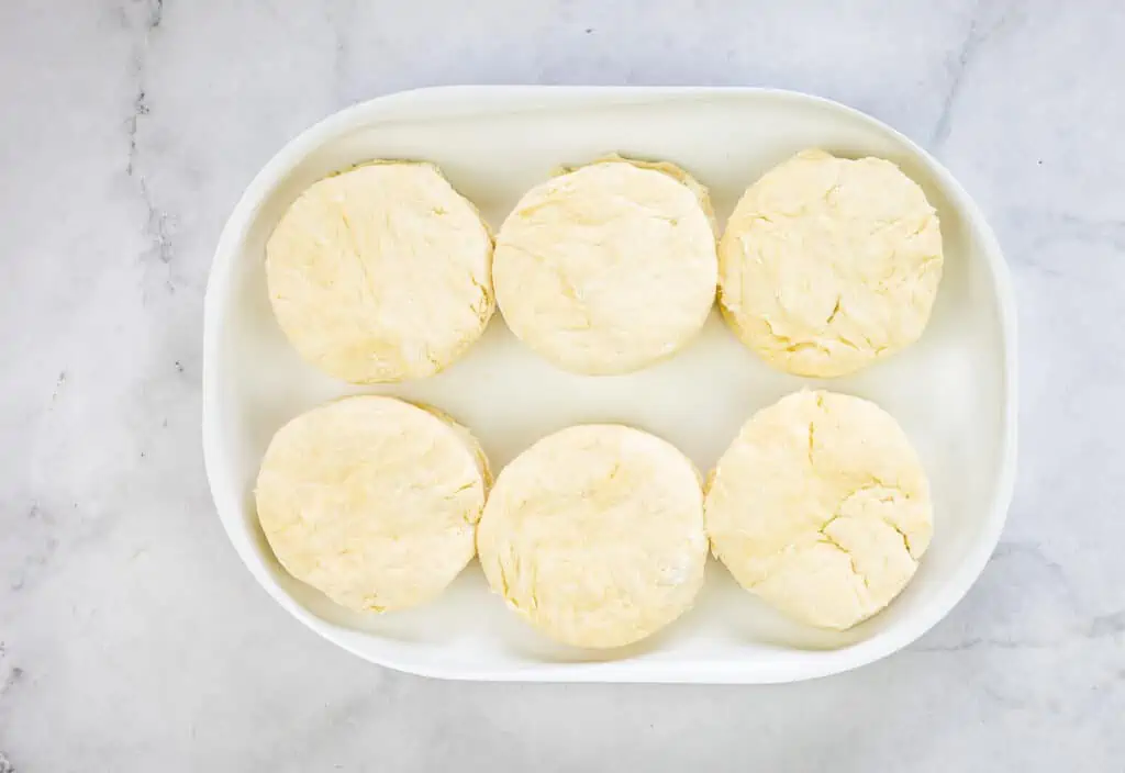 Cut out the biscuits from the final rectangle using a biscuit cutter.