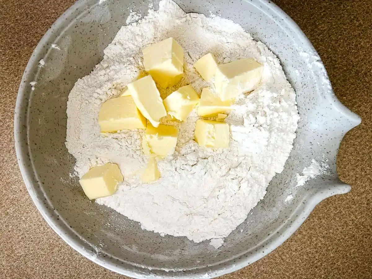 Cold cubed butter in the bowl with the flour.