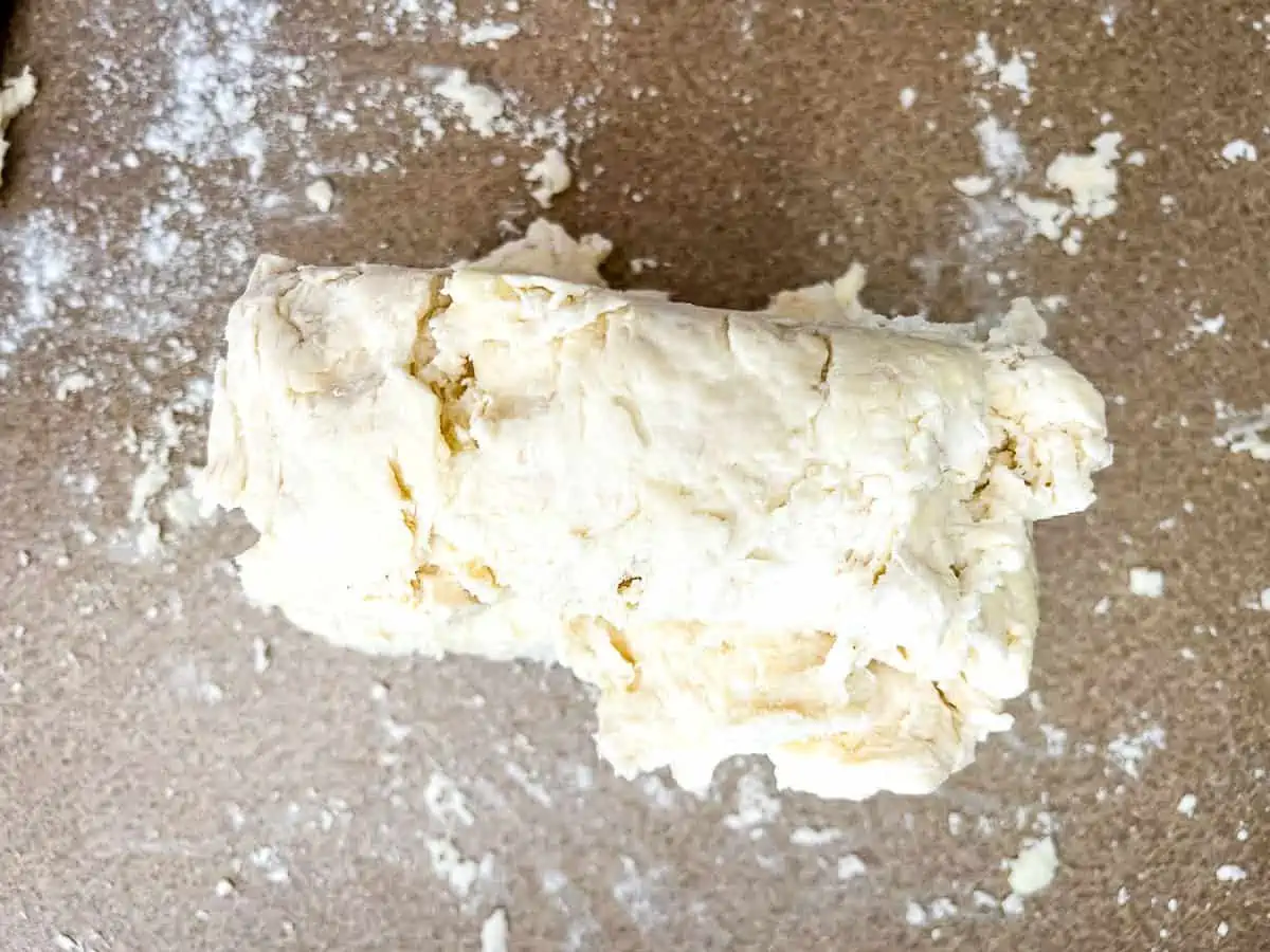Biscuit dough that's been folded, cut in half, and the halves stacked on top of each other.