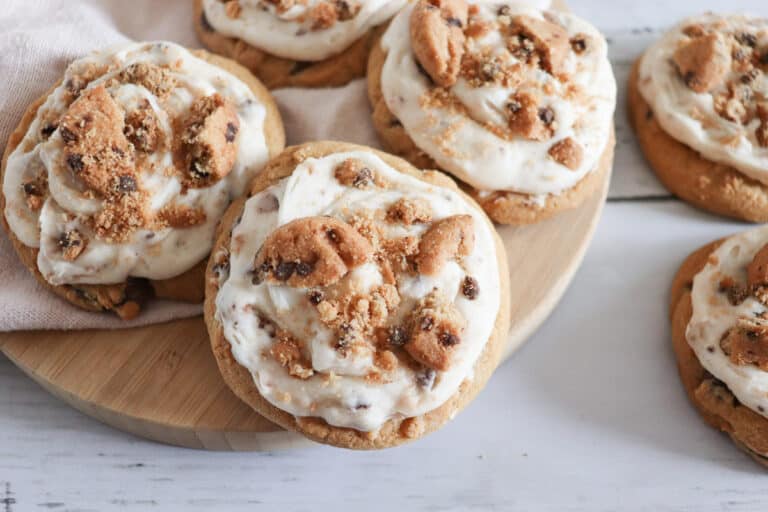 cookie frosted chocolate chip cookies on a board