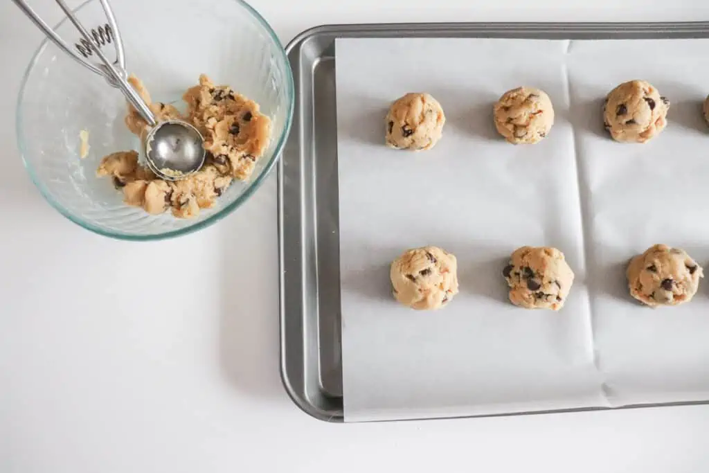 cookie dough scooped onto a baking sheet