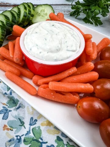 garlic dipping sauce on a plate with vegetables