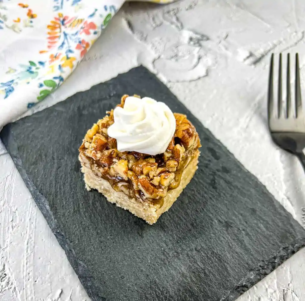 maple pecan pie bars on a black plate