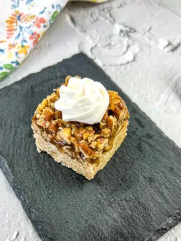 Maple Pecan Pie Bars on a black plate