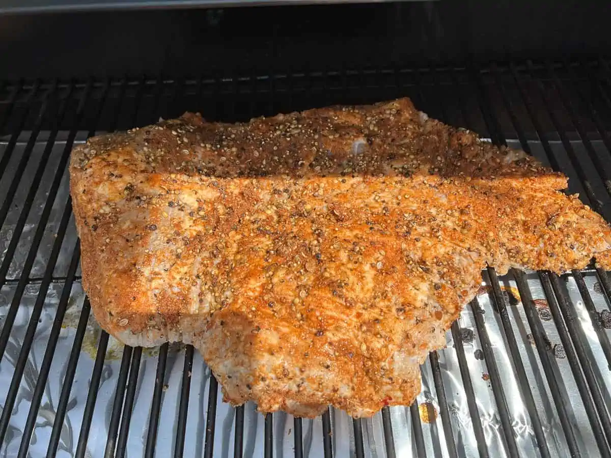 rubbed brisket on the smoker to make pastrami