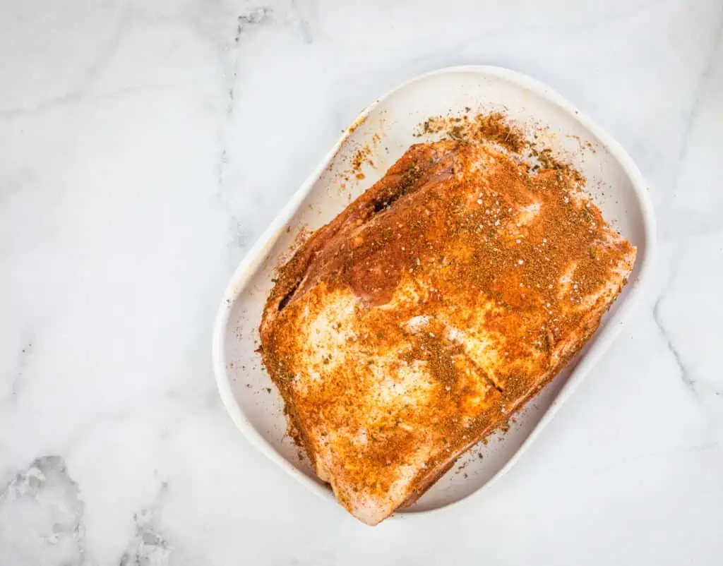 pork rubbed with spice mix to make dutch oven carnitas