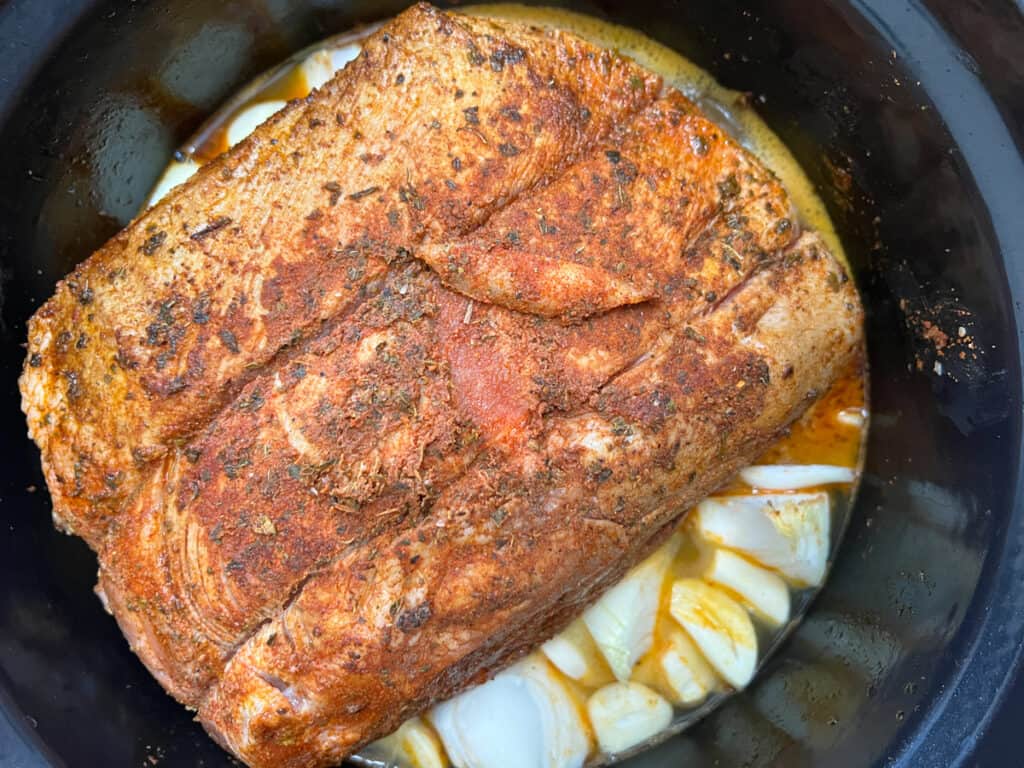 pork, juices, onions, and garlic in the dutch oven