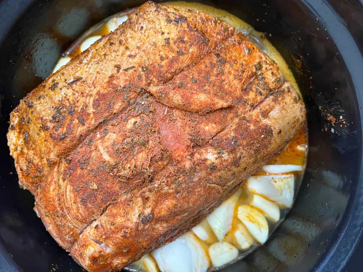 pork, juices, onions, and garlic in the dutch oven