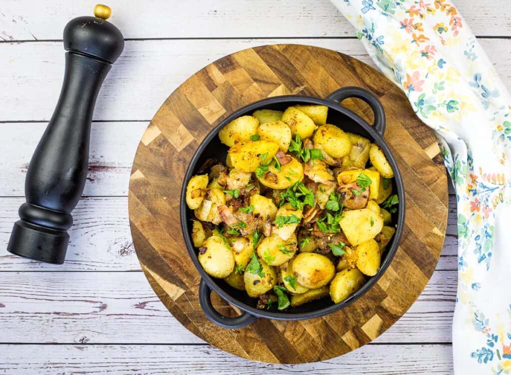 blackstone potatoes in a black bowl on a cutting board