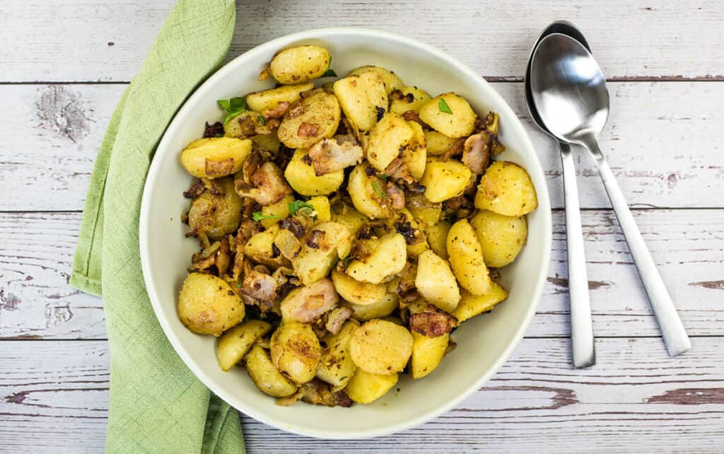 Finished blackstone potatoes in a serving bowl.