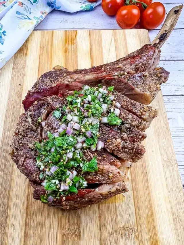 smoked tomahawk steak on a cutting board