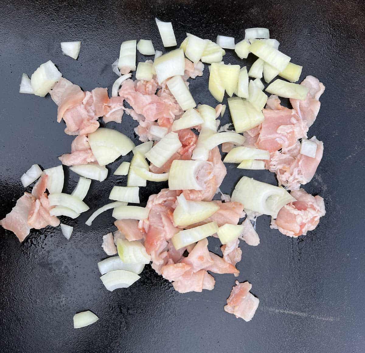 onion and bacon frying on the blackstone