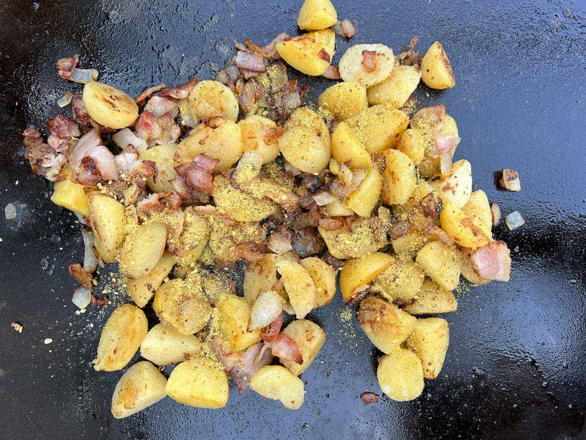 fry the potatoes, season, and combine with onions and bacon