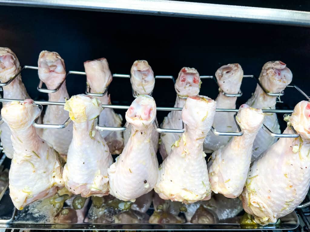 chicken legs on the rack in the smoker