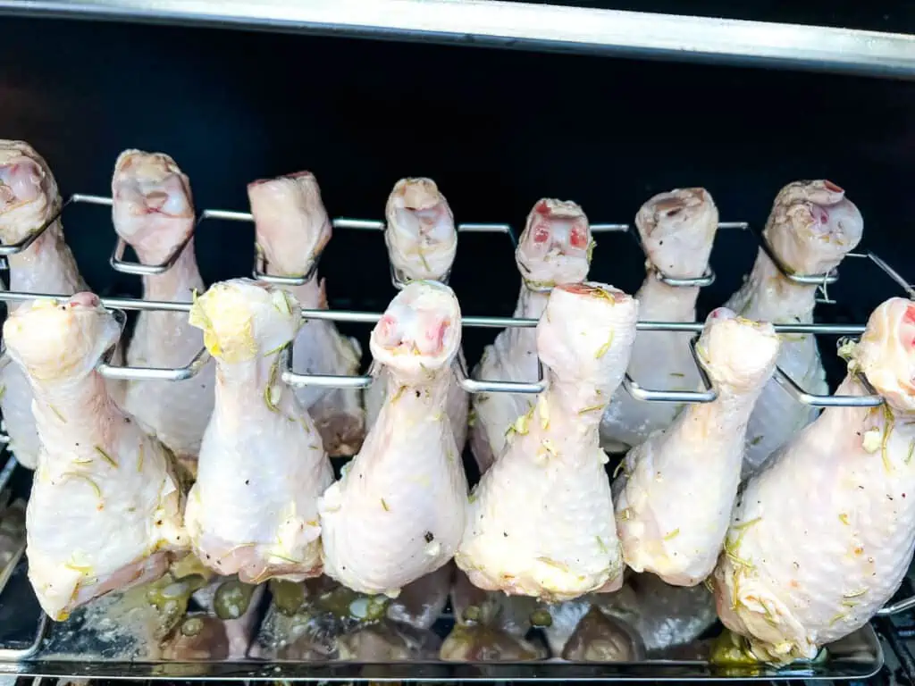 chicken legs on the rack in the smoker