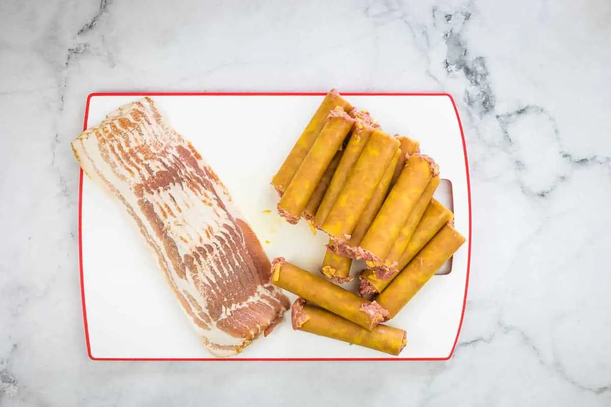 stuffed shotgun shells next to bacon slices