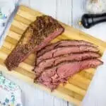 sliced smoked ribeye roast on a cutting board