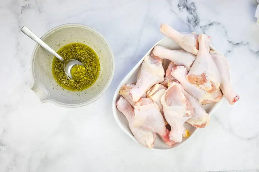 chicken seasoning in a bowl next to raw chicken legs