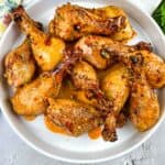 smoked chicken legs with bourbon red pepper glaze in a serving dish