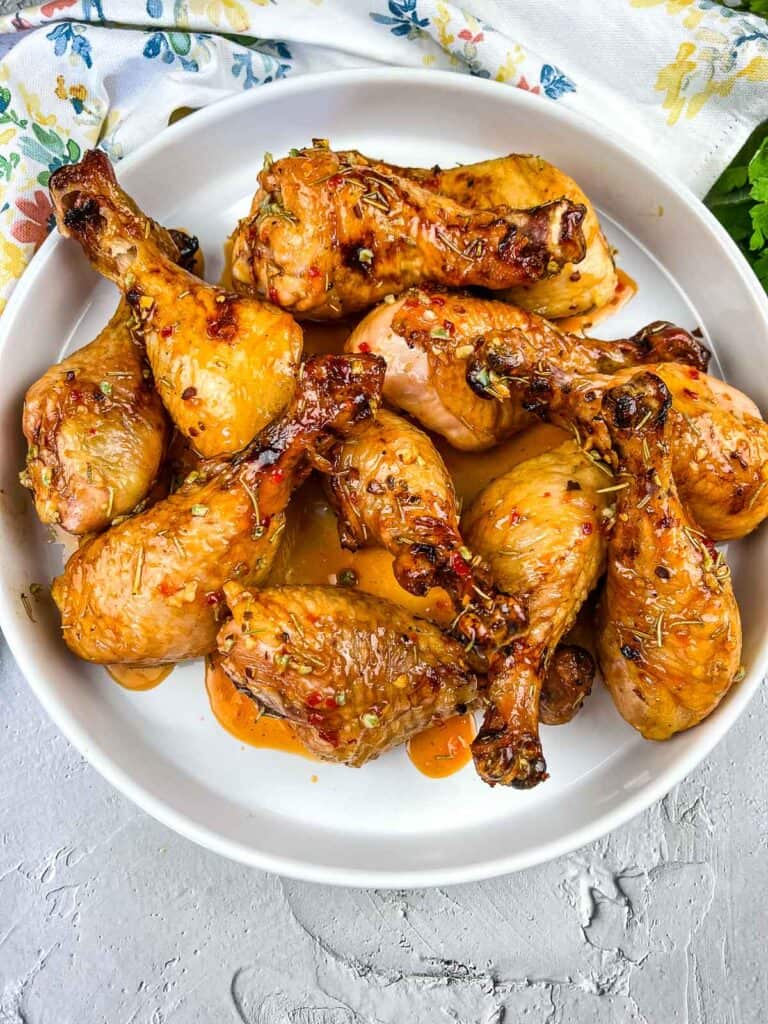smoked chicken legs with bourbon red pepper glaze in a serving dish