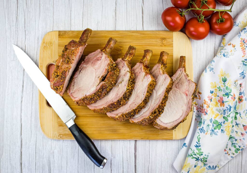 carved smoked rack of pork on a cutting board