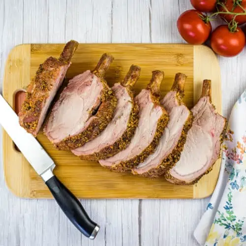 carved smoked rack of pork on a cutting board