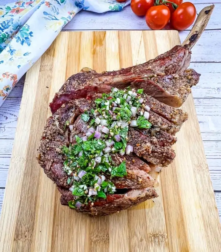 smoked tomahawk steak on a cutting board